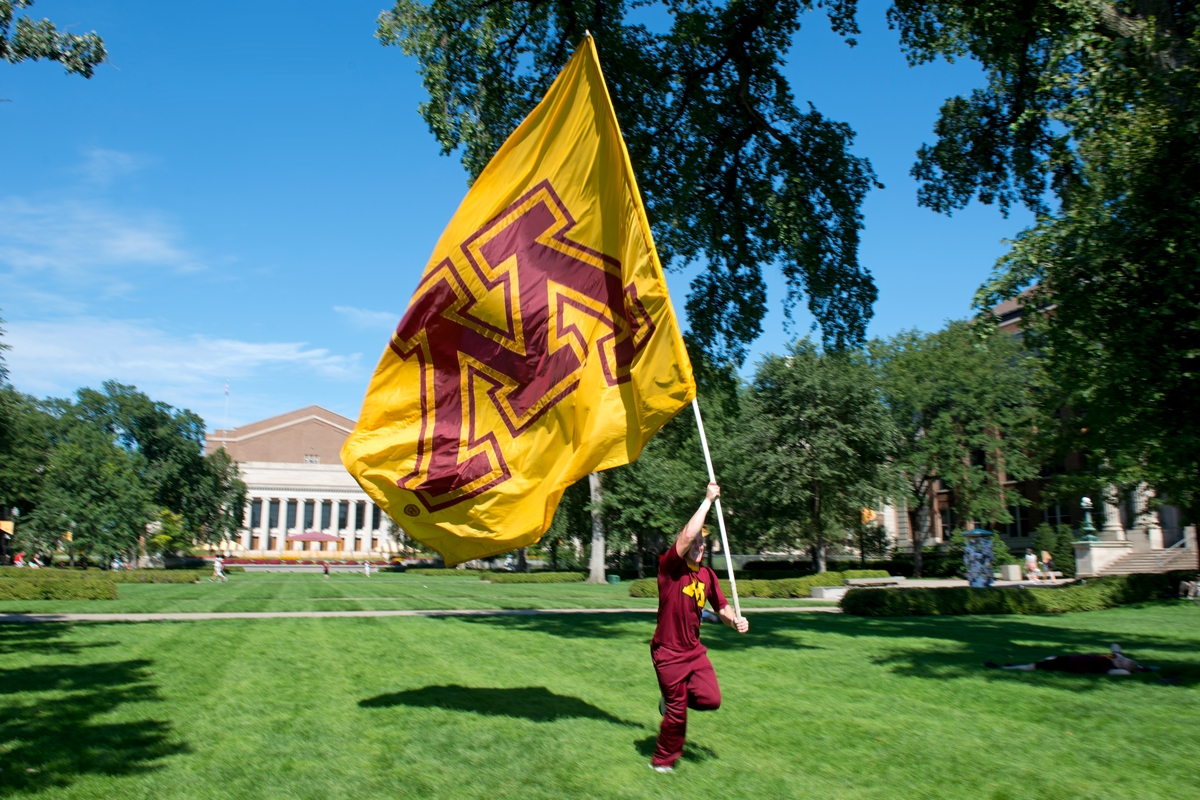 Student carrying a U of M flag